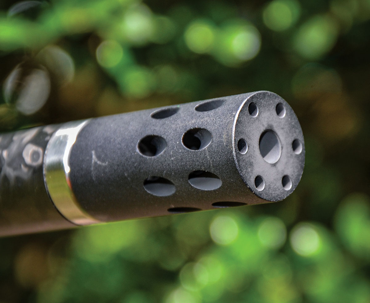 The attached muzzle brake with its back end resting against the barrel tensioning nut.